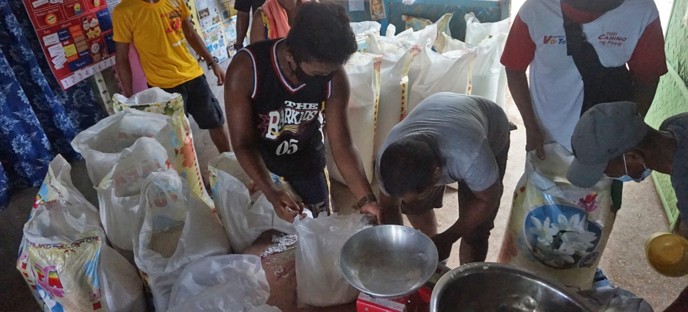 Community members of the Lakdayan ancestral domain actively lend a hand in the repacking of the emergency food relief