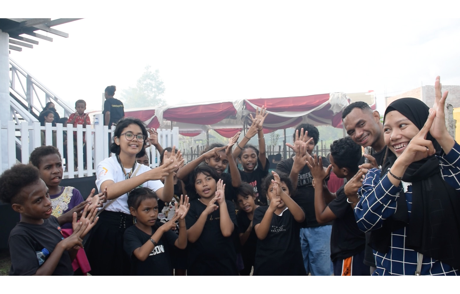 Deaf communities from Bogor, Merauke, and Sorong teach letters in Indonesian Sign Language to the students at Sekolah Alam Papua Paradise Center.
